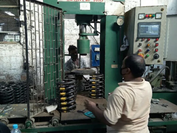 A worker working on a Spring Testing Machine